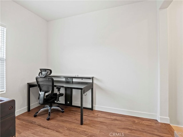office area featuring baseboards and wood finished floors