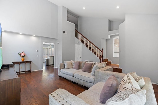 living room with visible vents, wood finished floors, a wealth of natural light, and stairway