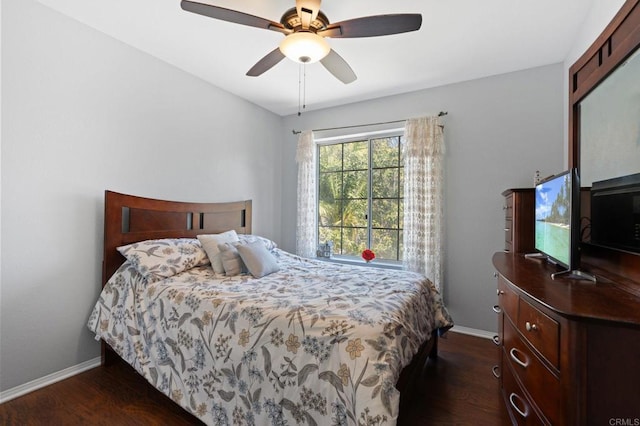 bedroom featuring baseboards, ceiling fan, and dark wood-style flooring