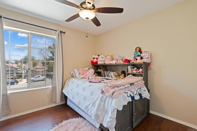 bedroom with baseboards, ceiling fan, and wood finished floors