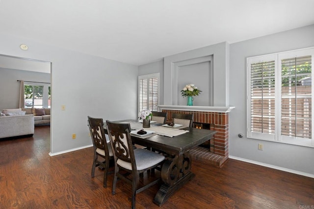 dining area with baseboards and wood finished floors