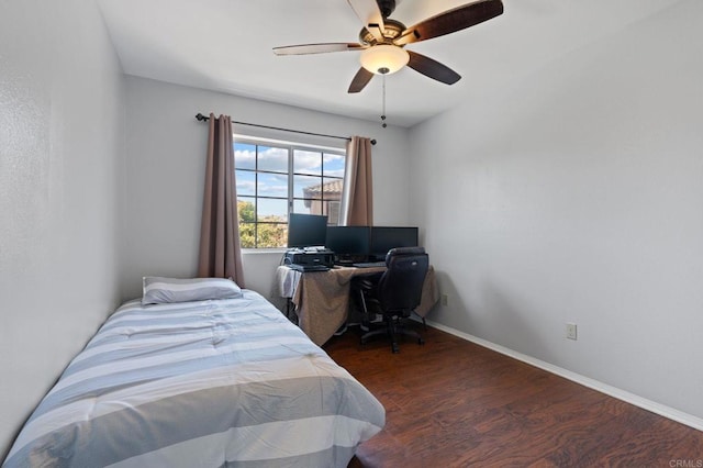 bedroom featuring baseboards, ceiling fan, and wood finished floors