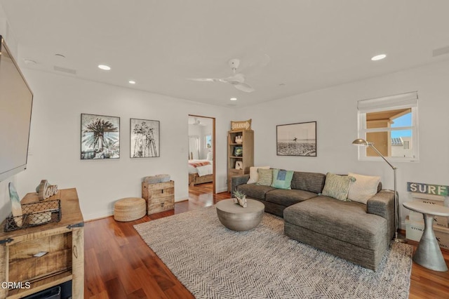 living room featuring recessed lighting, a ceiling fan, baseboards, and wood finished floors
