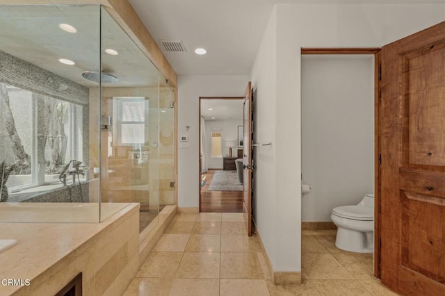 full bathroom featuring visible vents, a stall shower, tile patterned floors, baseboards, and toilet