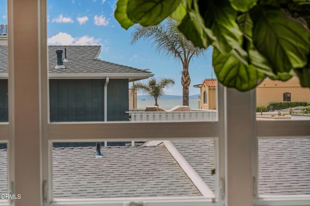 details featuring roof with shingles, a downspout, and gutters