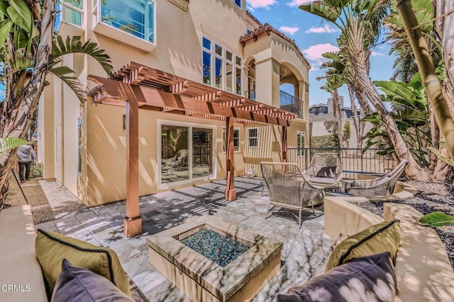 view of patio / terrace featuring a pergola and an outdoor living space with a fire pit