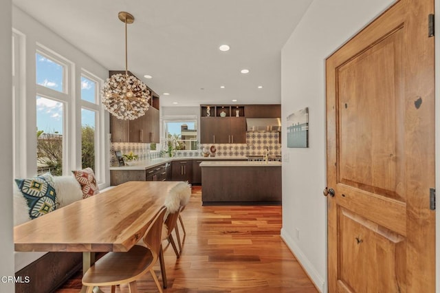 dining area featuring recessed lighting, baseboards, and light wood-style flooring