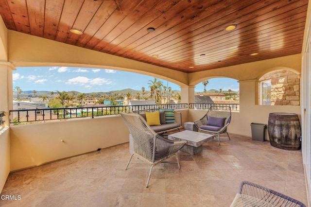 view of patio / terrace featuring a mountain view, an outdoor living space, and a balcony