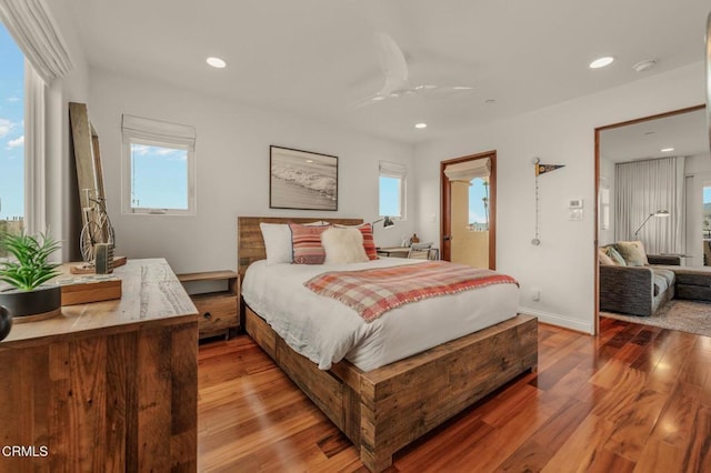 bedroom featuring recessed lighting, a ceiling fan, baseboards, and wood finished floors