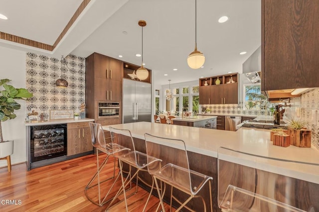 kitchen with backsplash, open shelves, light countertops, beverage cooler, and stainless steel appliances