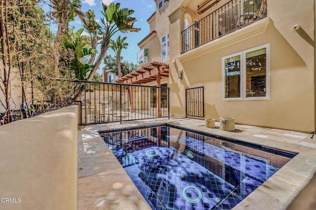 view of swimming pool featuring a hot tub