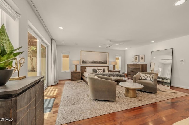 living room featuring recessed lighting, a ceiling fan, light wood-style floors, and baseboards