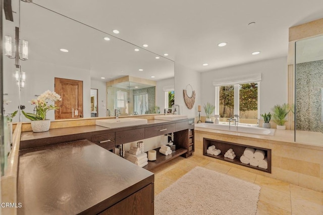 full bathroom featuring recessed lighting, a sink, a bath, and double vanity