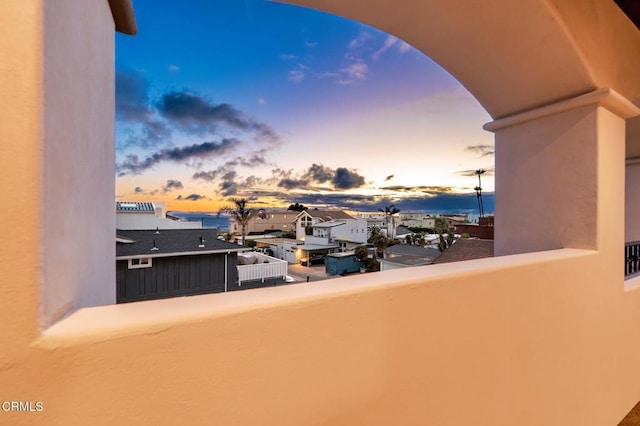 view of balcony at dusk