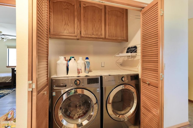 laundry area featuring cabinet space, ceiling fan, and washer and clothes dryer