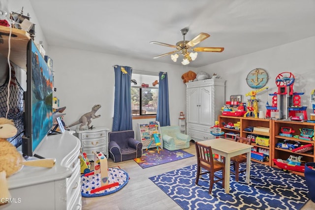 playroom with ceiling fan and wood finished floors