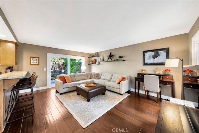 living room with baseboards and dark wood-style flooring