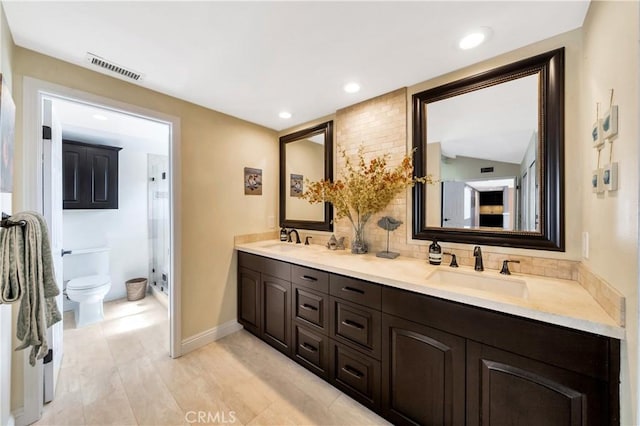 full bathroom with a sink, a shower stall, toilet, and visible vents