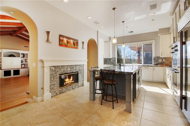 3988 Keri Way, Fallbrook, CA 92028 - kitchen with tasteful backsplash, a breakfast bar, stone counters, a kitchen island, and recessed lighting