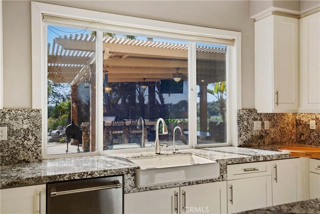 3988 Keri Way, Fallbrook, CA 92028 - kitchen with a sink, white cabinetry, decorative backsplash, stainless steel dishwasher, and light stone counters