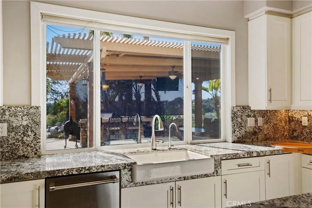 3988 Keri Way, Fallbrook, CA 92028 - kitchen with stainless steel dishwasher, white cabinets, decorative backsplash, and light stone countertops