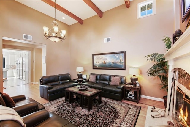 3988 Keri Way, Fallbrook, CA 92028 - living area featuring a towering ceiling, light wood-type flooring, a fireplace, beamed ceiling, and a chandelier