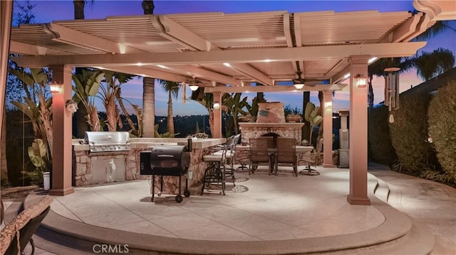 3988 Keri Way, Fallbrook, CA 92028 - patio terrace at dusk with an outdoor stone fireplace, grilling area, area for grilling, a pergola, and ceiling fan