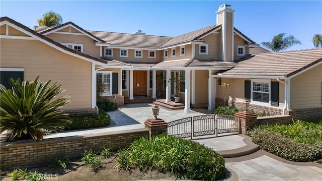 3988 Keri Way, Fallbrook, CA 92028 - view of front of property featuring a gate, a chimney, brick siding, a fenced front yard, and a tiled roof
