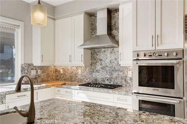3988 Keri Way, Fallbrook, CA 92028 - kitchen featuring wall chimney range hood, appliances with stainless steel finishes, light stone countertops, and white cabinetry