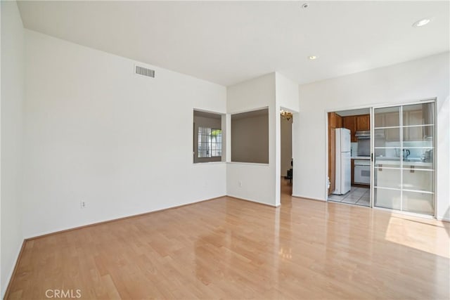 empty room with visible vents and light wood-type flooring
