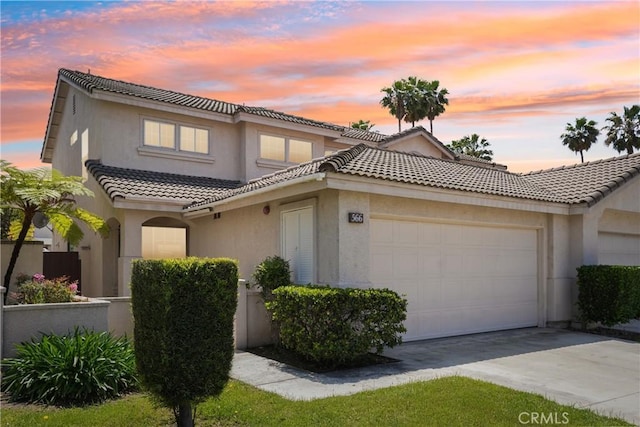 view of front of home with fence, a garage, stucco siding, concrete driveway, and a tiled roof