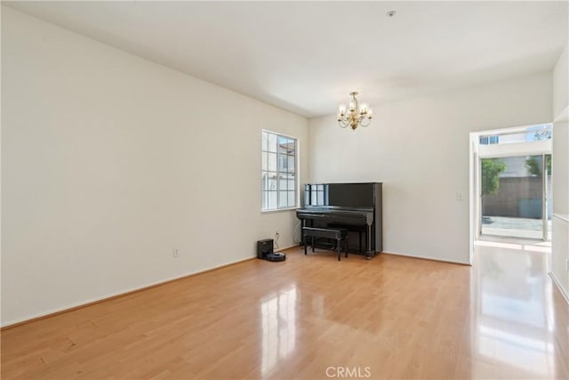 living area featuring wood finished floors and a chandelier