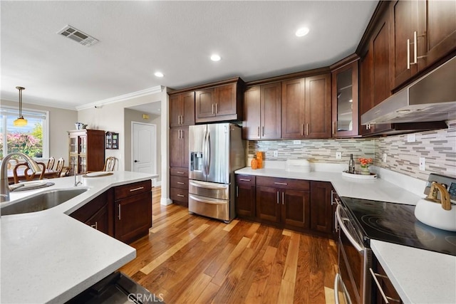 13837 Laguna St, La Mirada, CA 90638 - kitchen with light wood-style flooring, appliances with stainless steel finishes, a sink, and visible vents