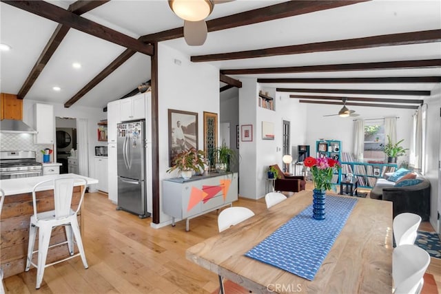 dining area featuring stacked washing maching and dryer, ceiling fan, recessed lighting, lofted ceiling with beams, and light wood finished floors