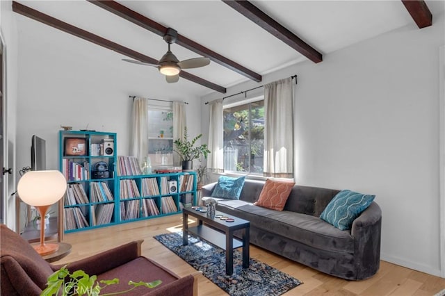 living room featuring wood finished floors, ceiling fan, and beam ceiling