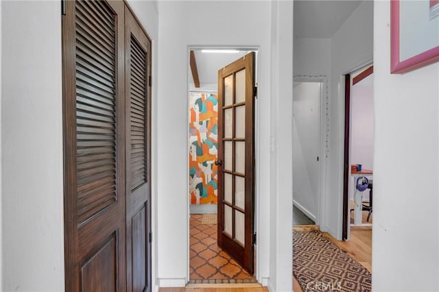 hallway featuring light wood-type flooring and visible vents