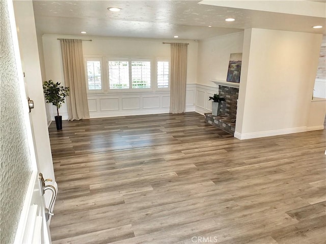 729 E Emerson Ave, Orange, CA 92865 - unfurnished living room with recessed lighting, ornamental molding, wood finished floors, and a wainscoted wall