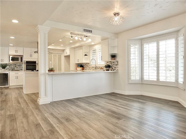 729 E Emerson Ave, Orange, CA 92865 - kitchen with visible vents, appliances with stainless steel finishes, tasteful backsplash, open shelves, and beverage cooler