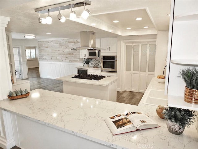 729 E Emerson Ave, Orange, CA 92865 - kitchen with island exhaust hood, crown molding, appliances with stainless steel finishes, wood finished floors, and a raised ceiling