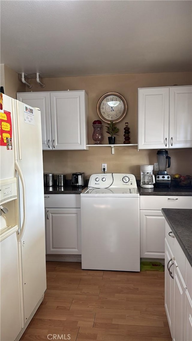 laundry room with laundry area, light wood finished floors, and washer / clothes dryer