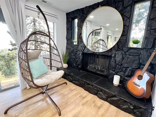 sitting room featuring visible vents and wood finished floors