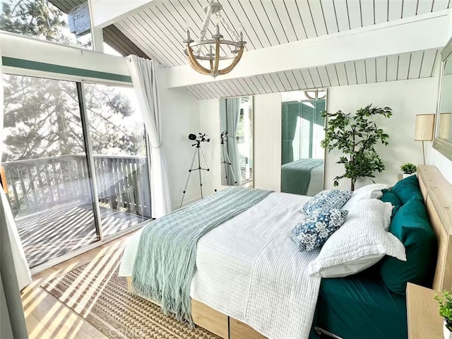 bedroom with an inviting chandelier, wood finished floors, vaulted ceiling with beams, and access to exterior