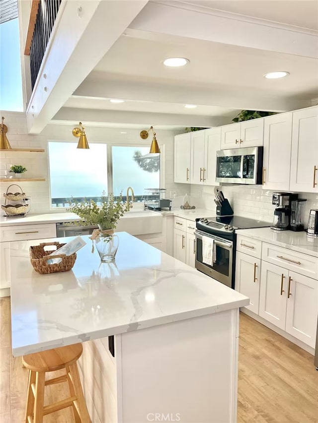 2012 Poplar Dr, Running Springs, CA 92382 - kitchen featuring appliances with stainless steel finishes, a sink, a center island, tasteful backsplash, and recessed lighting
