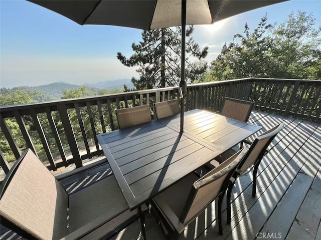 exterior space featuring a mountain view and outdoor dining area