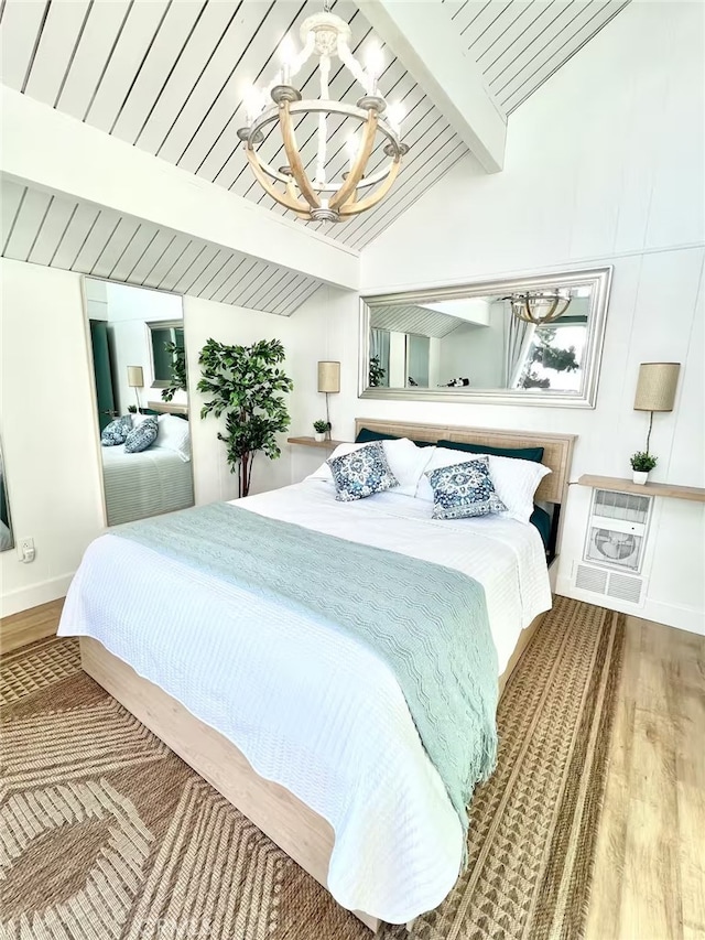 bedroom with vaulted ceiling with beams, baseboards, wood finished floors, and a chandelier