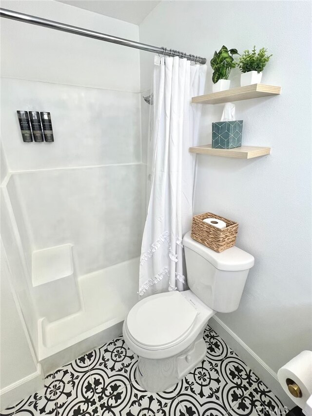 full bath with tile patterned floors, baseboards, toilet, and a shower with shower curtain