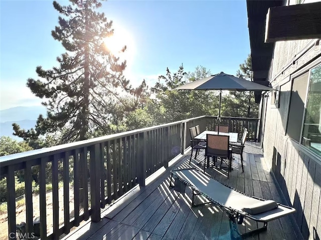 deck with outdoor dining area