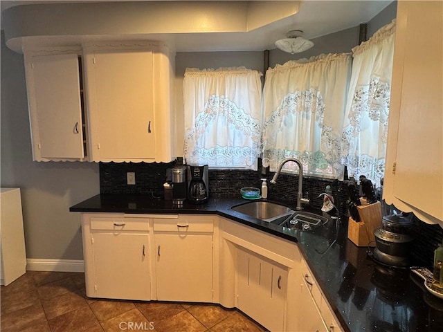 812 N Dickel St, Anaheim, CA 92805 - kitchen with a sink, baseboards, dark countertops, and tile patterned floors