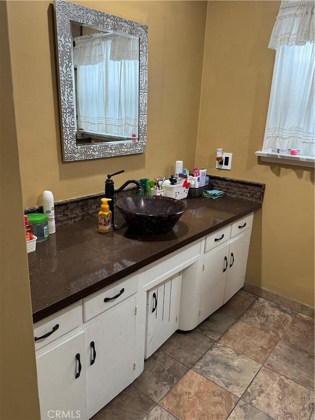 812 N Dickel St, Anaheim, CA 92805 - bathroom featuring stone tile floors, vanity, and baseboards
