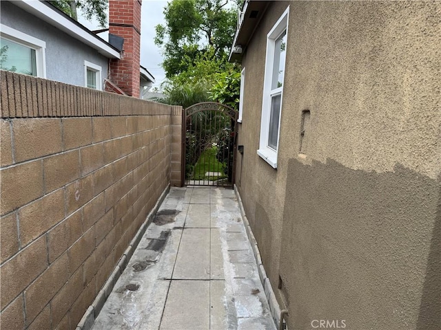 812 N Dickel St, Anaheim, CA 92805 - view of side of home with stucco siding, fence, and a gate